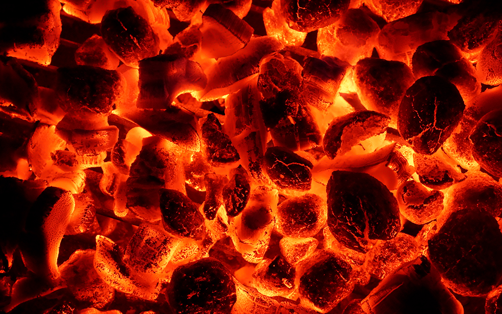 Background texture with glowing hot charcoal briquettes